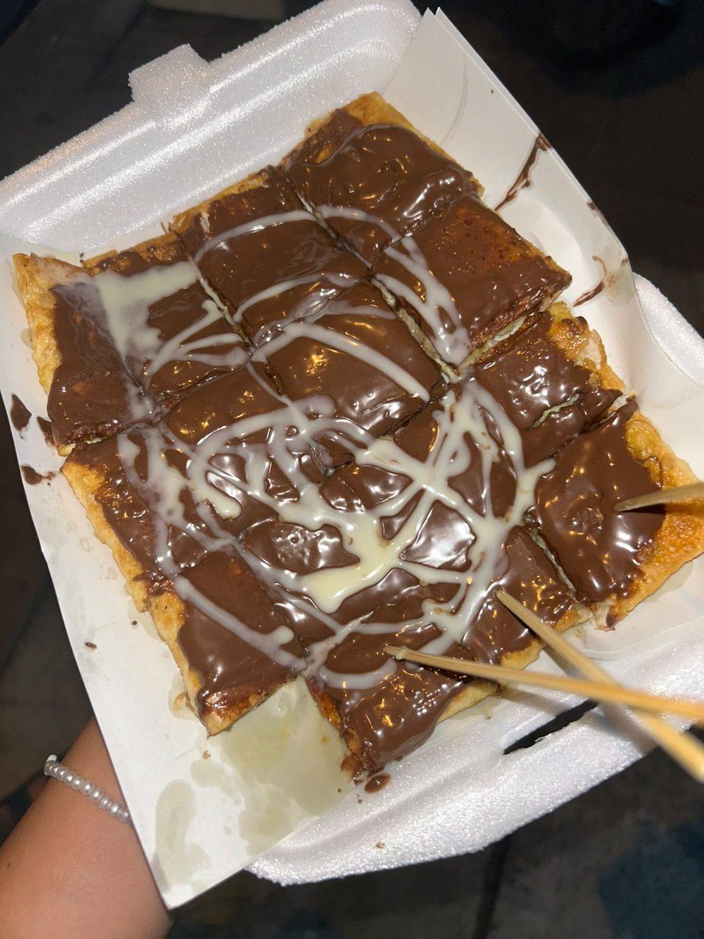 Chocolate and condensed milk roti in a takeaway box
