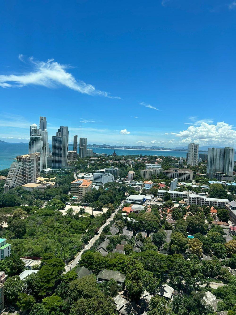 Pattaya bay with high-rise buildings under a blue sky